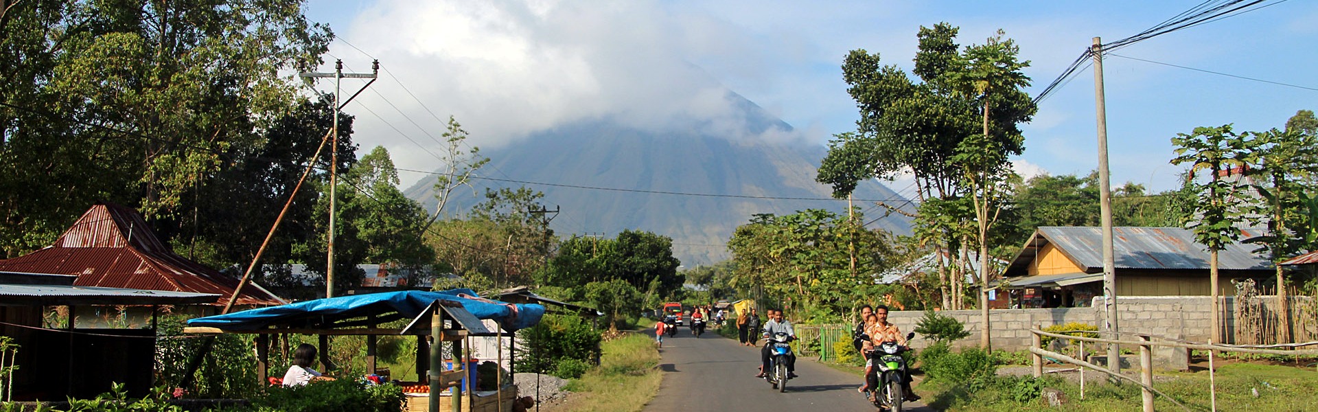 Locals live in the shadow of active Mt Inerie volcano, central , Indonesia